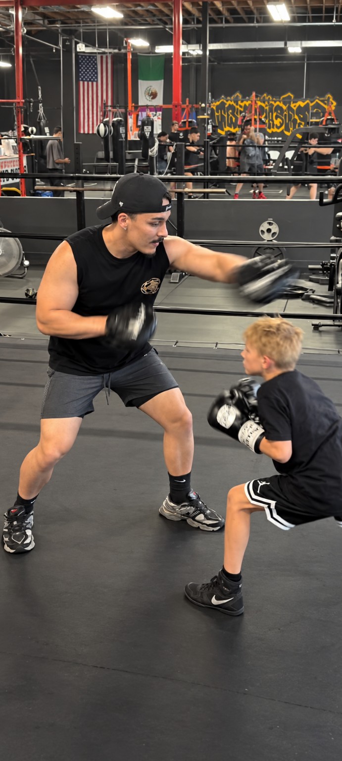 Young boxer practicing defense during a personal coaching session at PunchTown.
