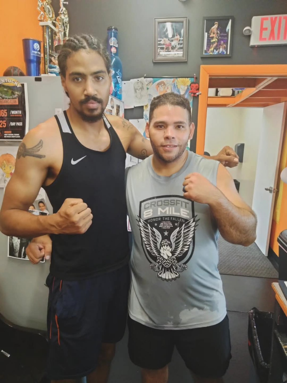 Coach and boxer posing together after a personal training session at PunchTown.