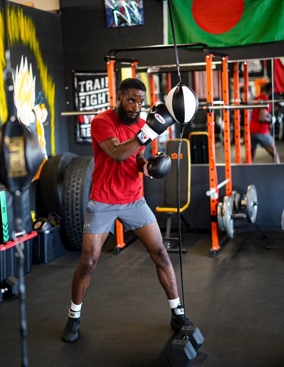 A boxer works the double-end speed bag during a fundamentals session