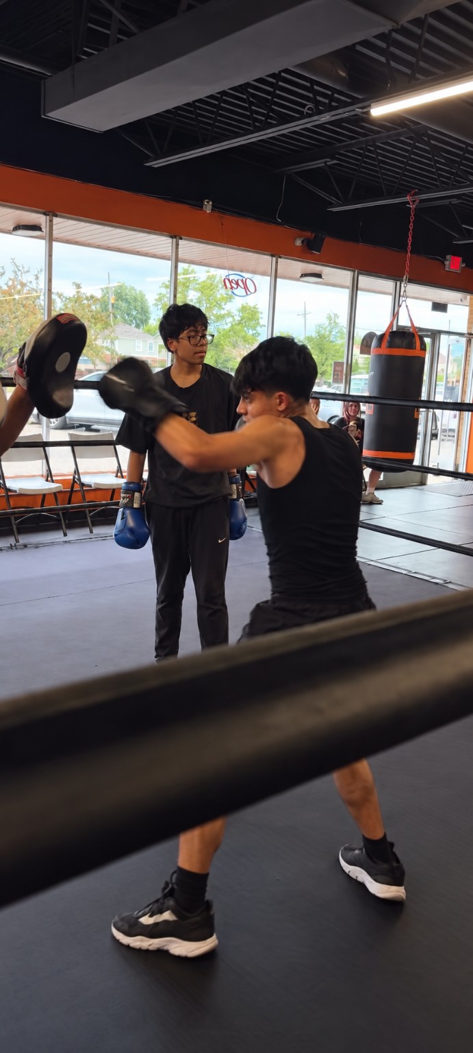 Boxers practice mitt work together inside the PunchTown ring
