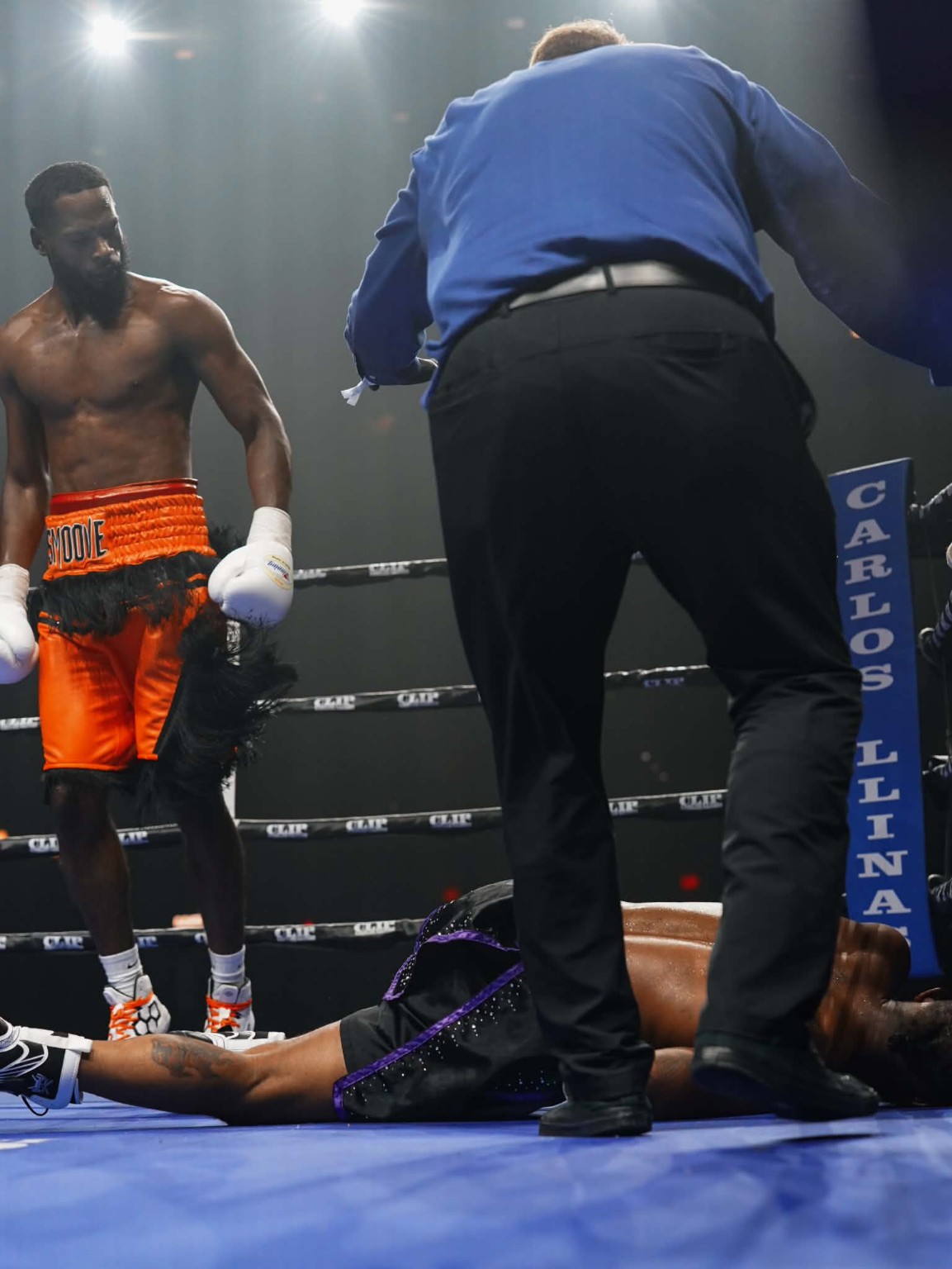 Bryant “Too Smoove” Brown standing in the ring as the referee attends to his opponent on the canvas